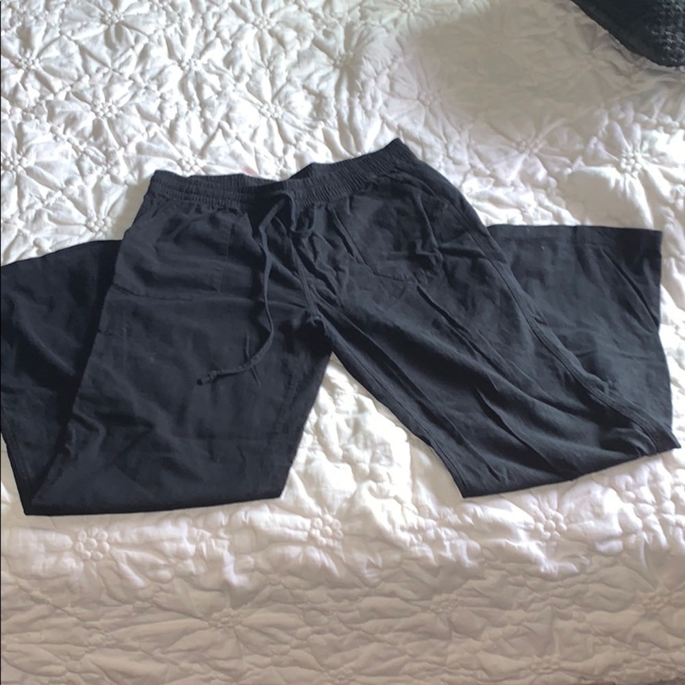 Loose black pants with a flare on the bottom